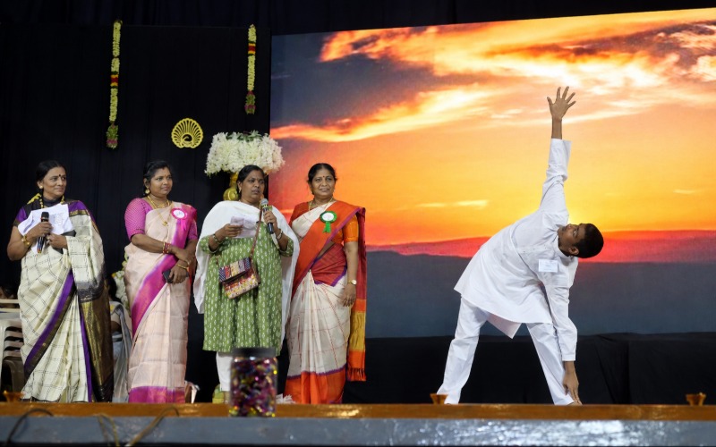 Student performing yoga on stage during a school event